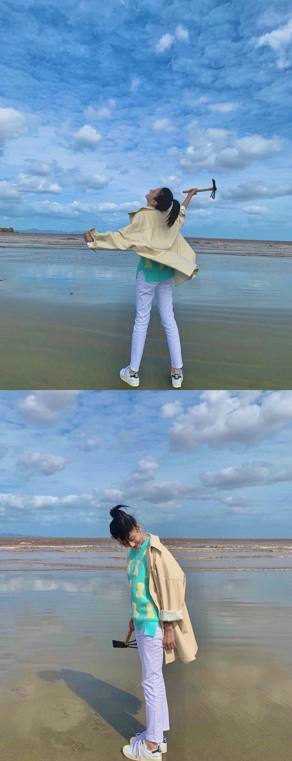 照片中宋祖儿在海边穿着湖蓝色小鸭毛衣,搭配牛仔裤和卡其色风衣,头发