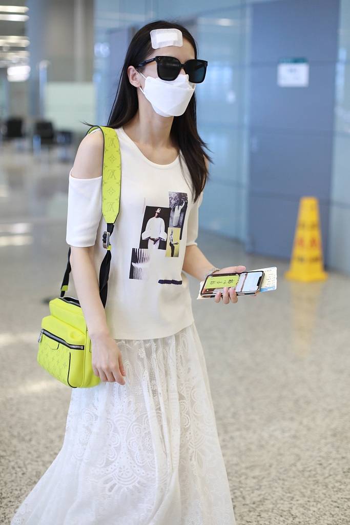 黄圣依头部受伤贴纱布现身机场 甜美比心清纯可人