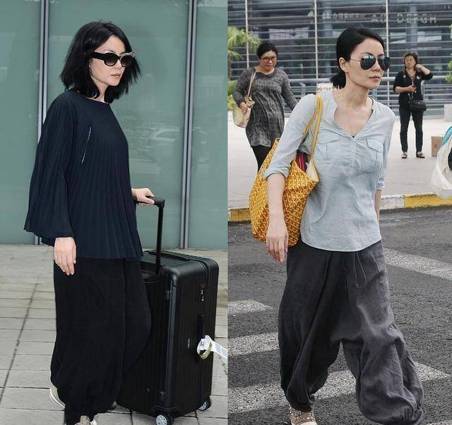 曾经,王菲穿了一件灰色的打底衫叠穿了条纹的上衣,看着很低调.