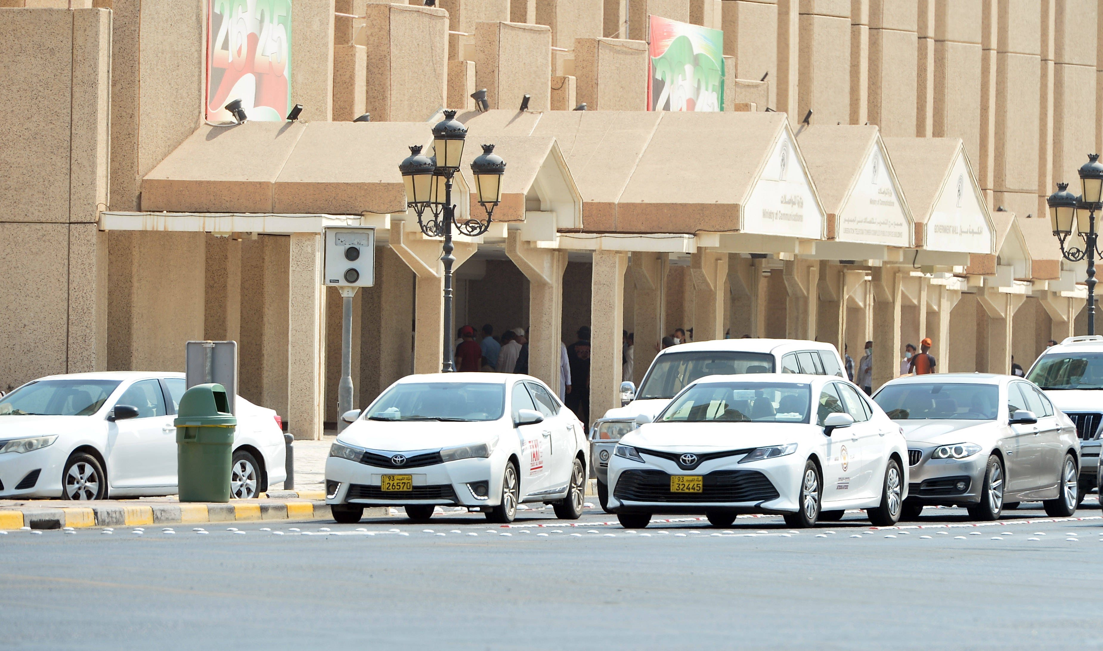 7月28日,在科威特首都科威特城,一名复工的出租车司机给汽车加油.