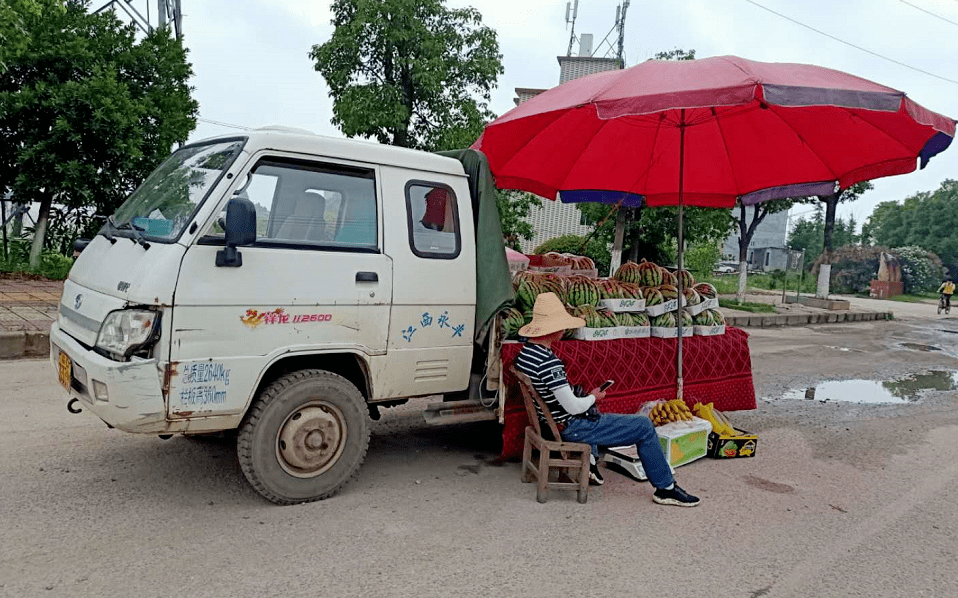 货车三轮车为据点就会吆喝一声每当有路人路过他们的西瓜摊时"买瓜么?