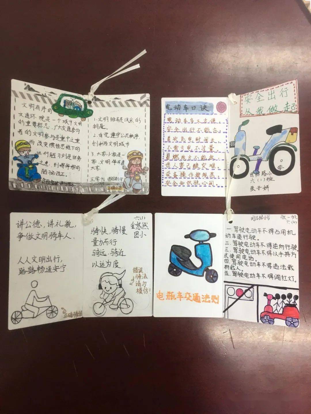 部分学生志愿者在学校附近向市民发放文明交通手绘小卡片