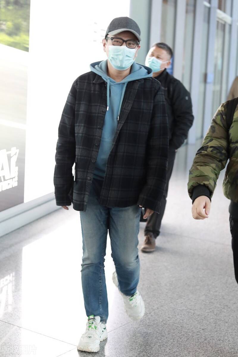 男神张信哲现身机场,蓝色卫衣配格外外套儒雅有气质