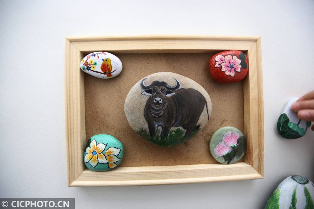 江苏泰州艺人赶制生肖牛石头画